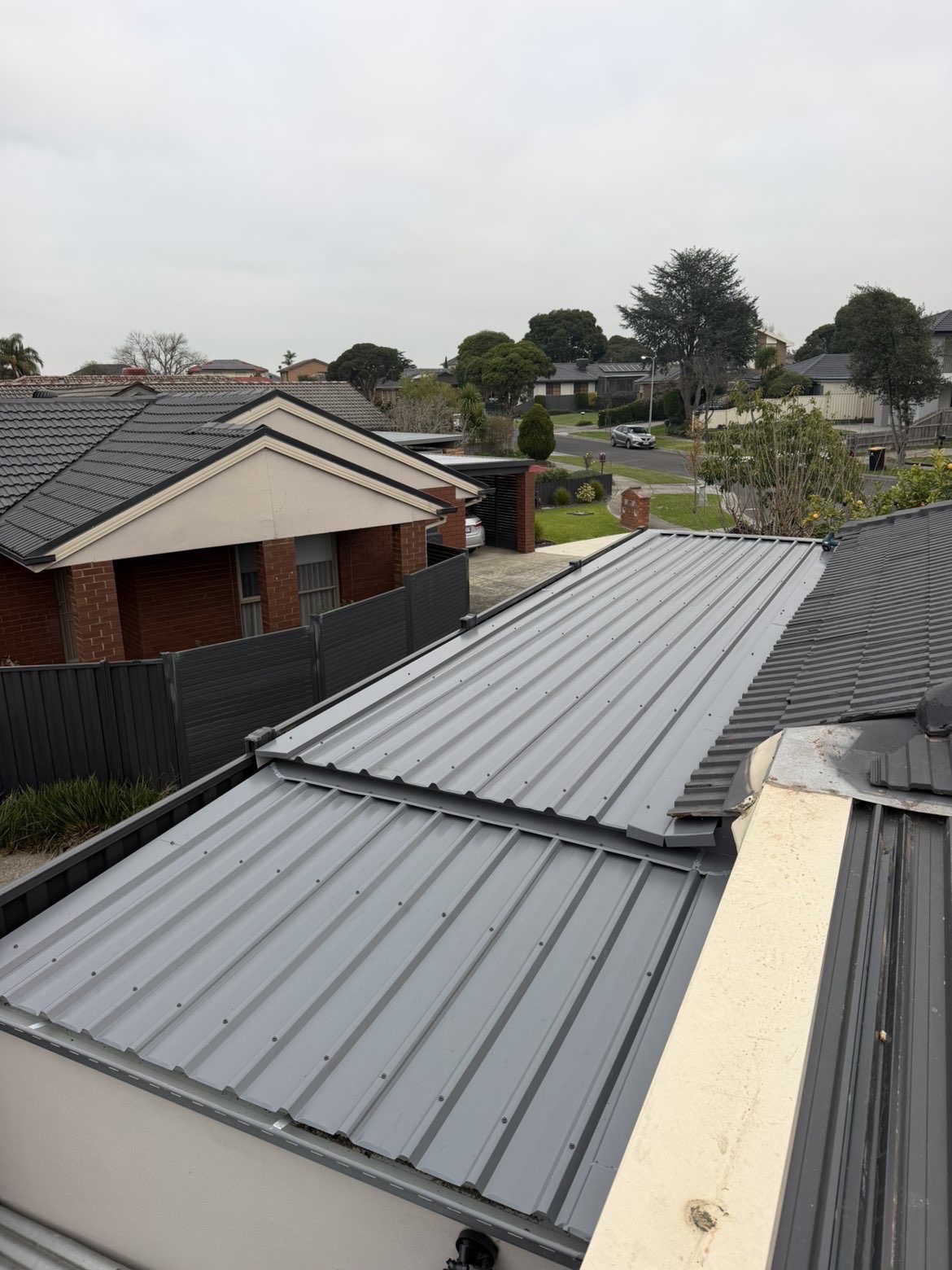 Grey corrugated metal roof section on a residential home