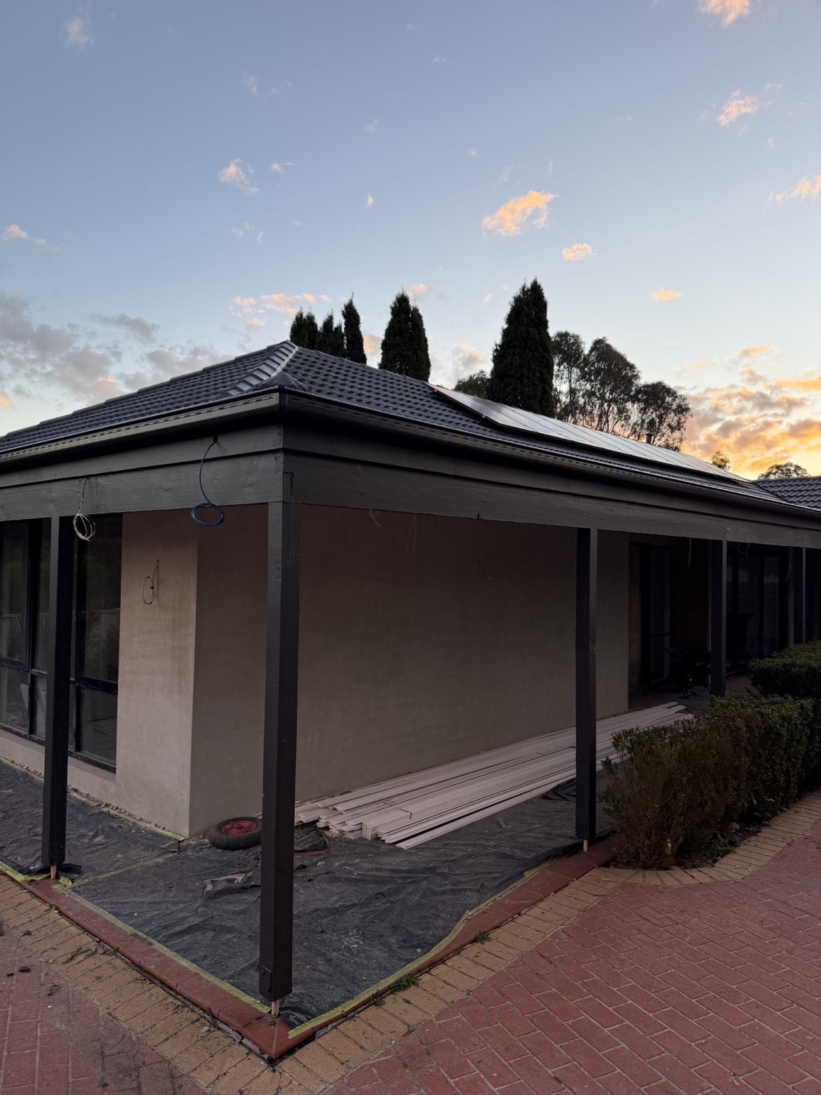 Roofing installed over a patio area at sunset