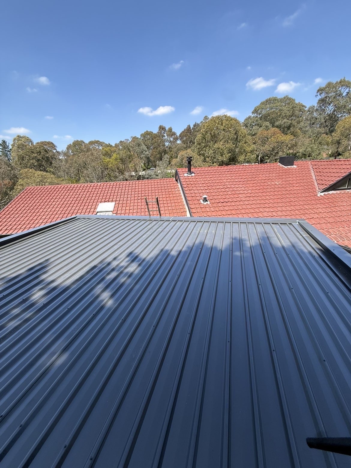 Blue metal roof installation viewed across the roof plane in Melbourne