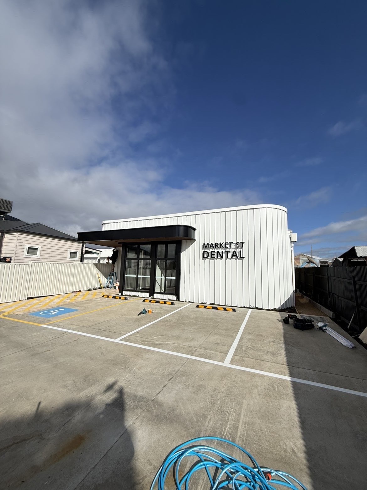 Curved white metal wall panels on a commercial building