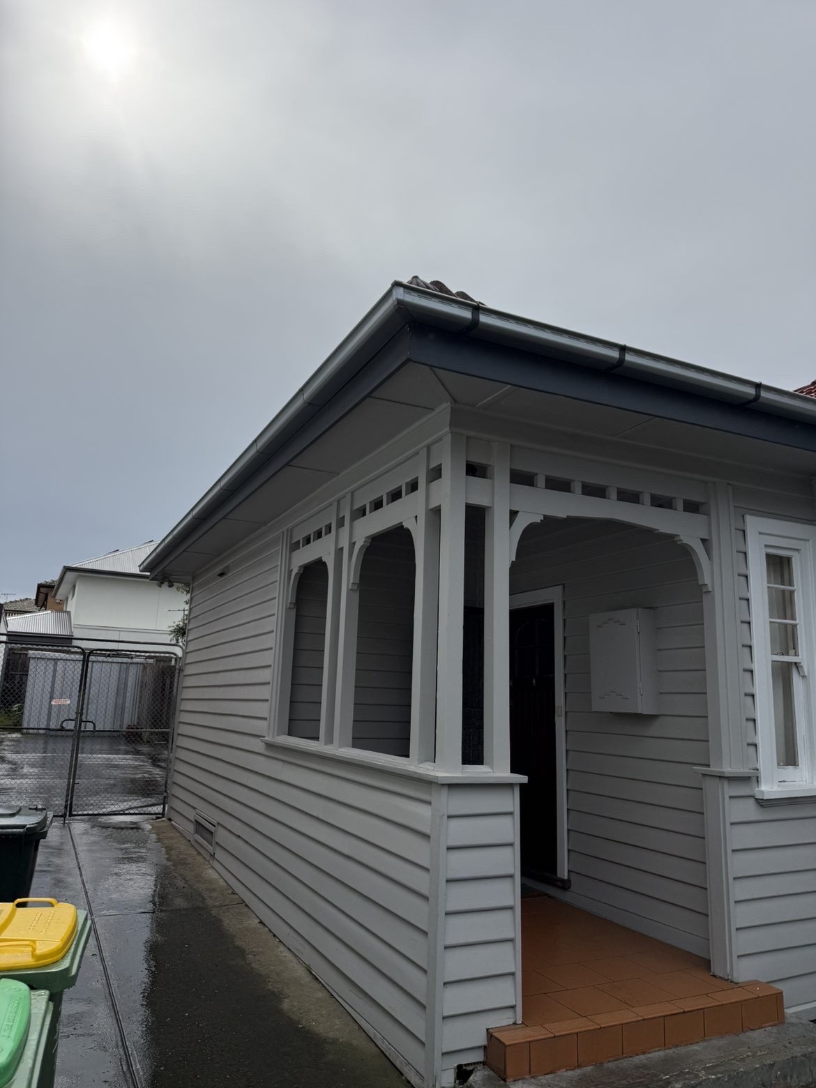 Front porch of a weatherboard home with detailed timber work