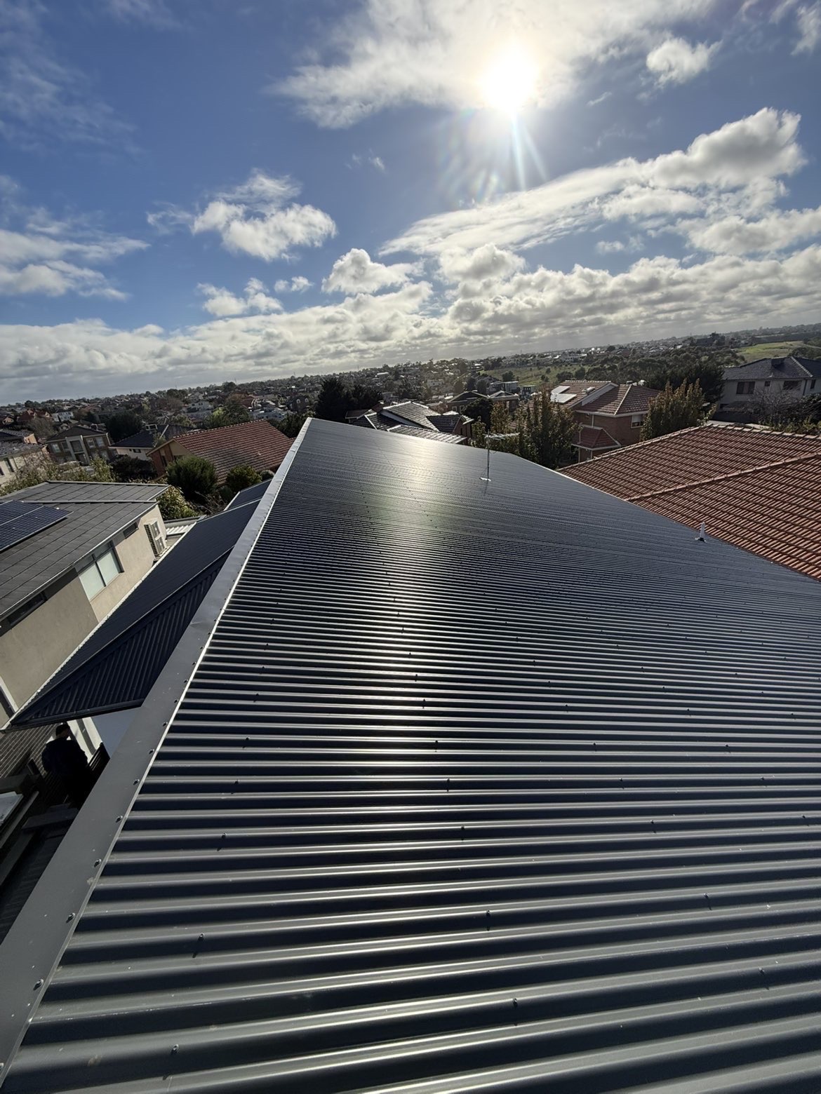 Second view of a completed black metal roof installation