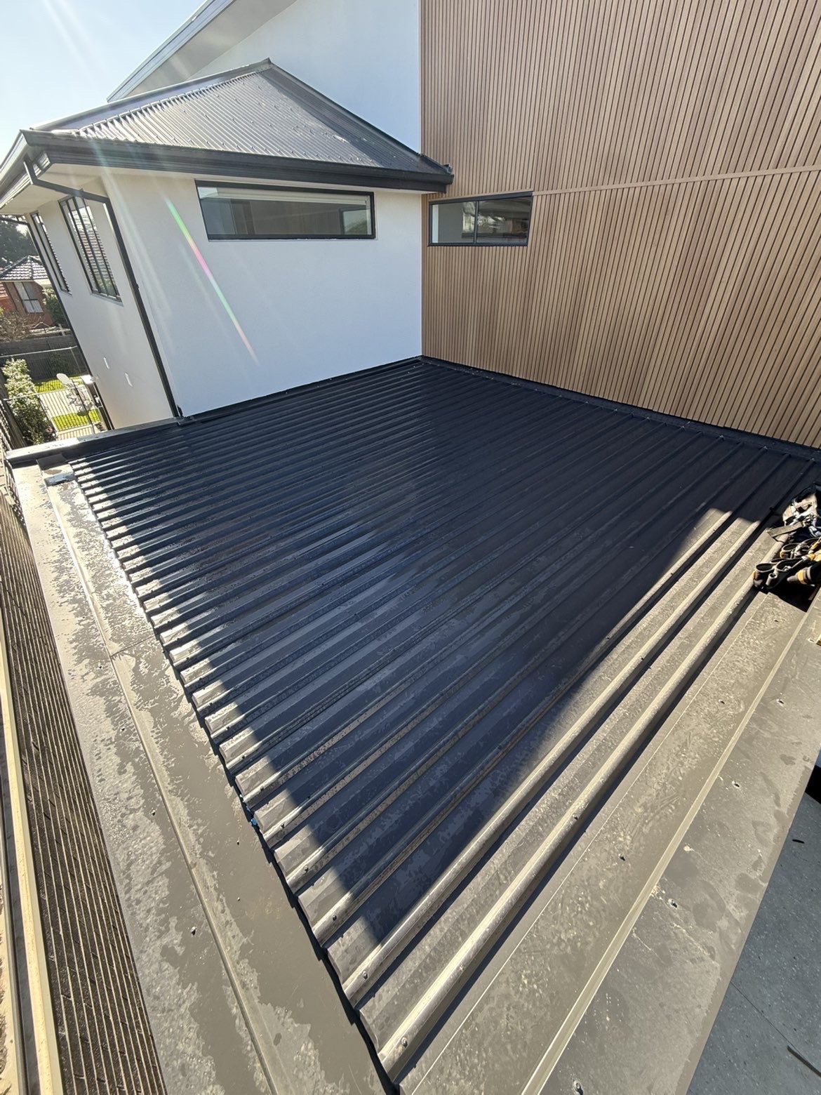 Dark grey metal roof installed on a modern Melbourne home