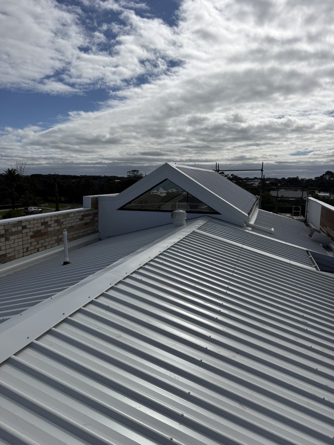 Light grey metal roof with a triangular skylight feature