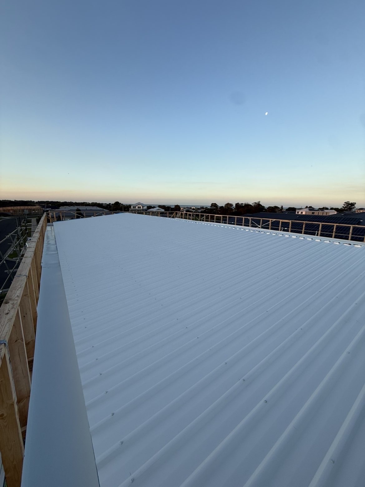 Long run of commercial metal roofing installed on a Melbourne building